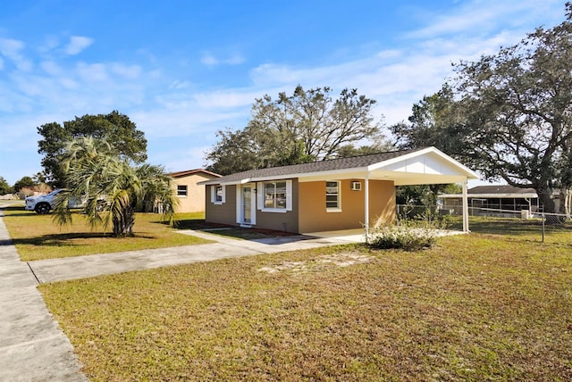 view of front of property featuring a carport and a front lawn