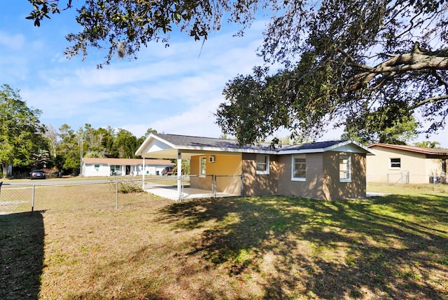 rear view of house with a yard