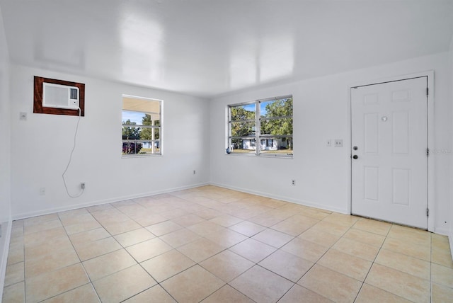 tiled spare room featuring a wall mounted AC