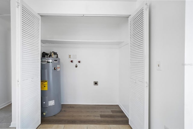 clothes washing area featuring hookup for an electric dryer, electric water heater, hardwood / wood-style flooring, and washer hookup