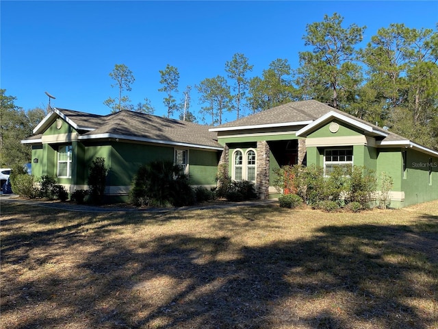 ranch-style home with a front yard