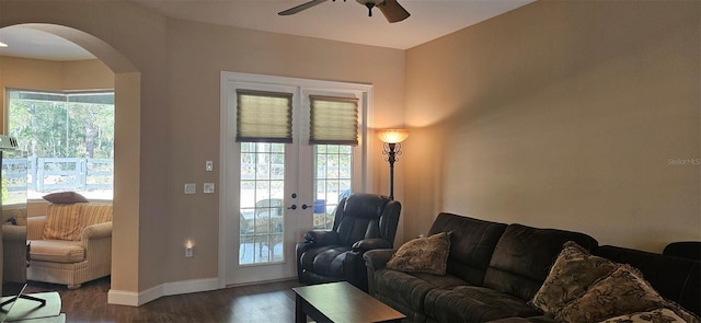 living room featuring ceiling fan, dark hardwood / wood-style floors, french doors, and a healthy amount of sunlight