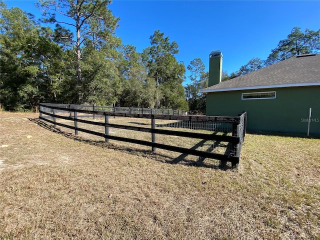 view of gate with a yard