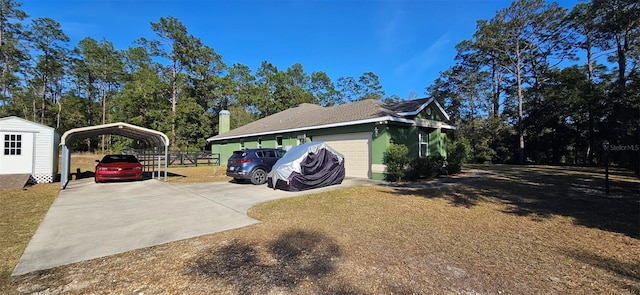 view of side of home with a carport and a storage unit