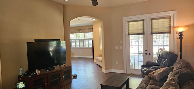 living room featuring ceiling fan, wood-type flooring, and french doors