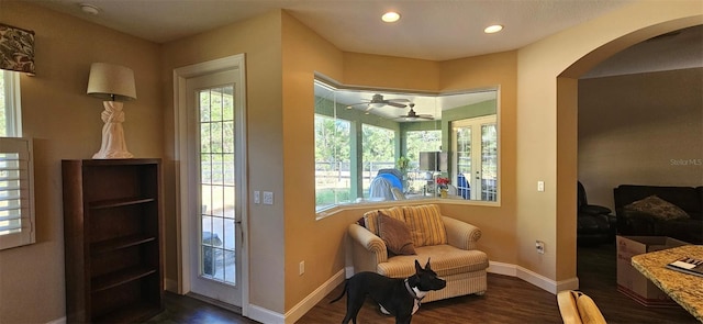 doorway to outside featuring ceiling fan and dark hardwood / wood-style floors