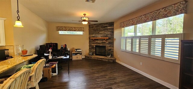 living room featuring dark wood-style floors, a fireplace, baseboards, and ceiling fan