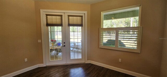 doorway to outside with french doors, baseboards, and dark wood-style floors