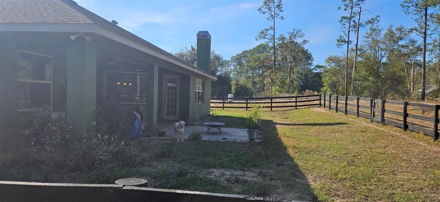 view of yard with a fenced backyard and an outdoor fire pit