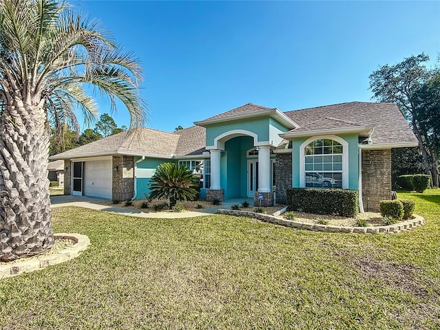 view of front of house with a garage and a front lawn