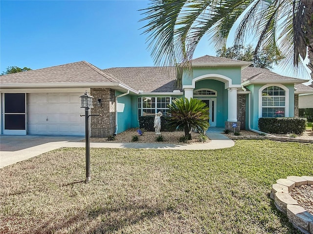 view of front of property with a garage and a front yard