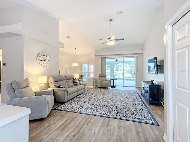 living room featuring ceiling fan, high vaulted ceiling, and light hardwood / wood-style floors