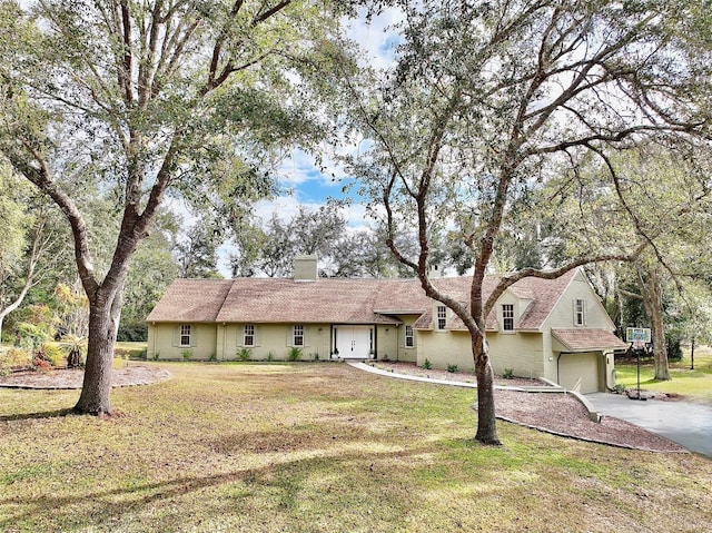 ranch-style house with a front yard and a garage