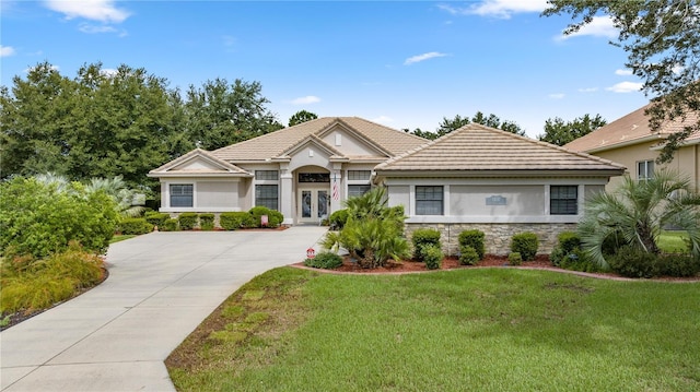 view of front of property featuring french doors and a front lawn