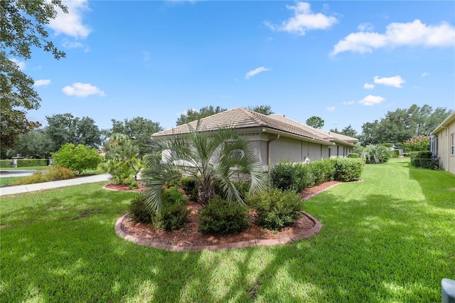 view of side of home featuring a yard