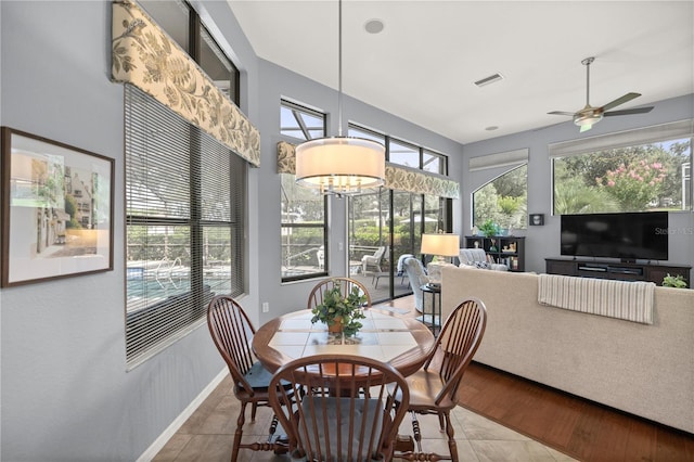 tiled dining space featuring ceiling fan