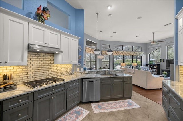 kitchen featuring white cabinets, ceiling fan, hanging light fixtures, and appliances with stainless steel finishes