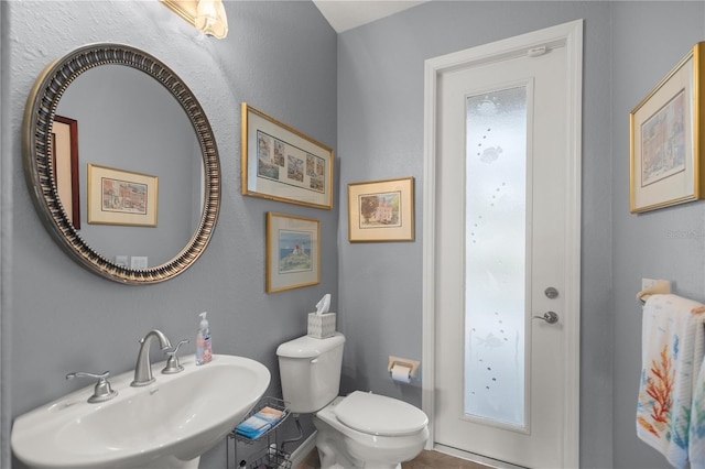 bathroom with sink, tile patterned flooring, and toilet