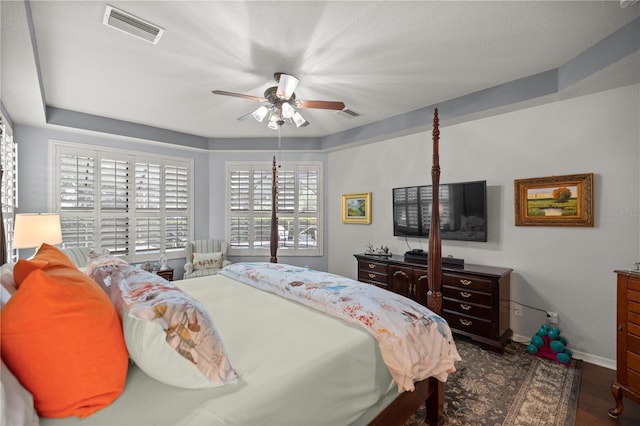 bedroom with ceiling fan and dark wood-type flooring