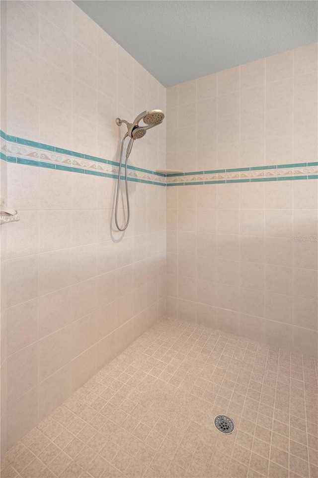 bathroom with a tile shower