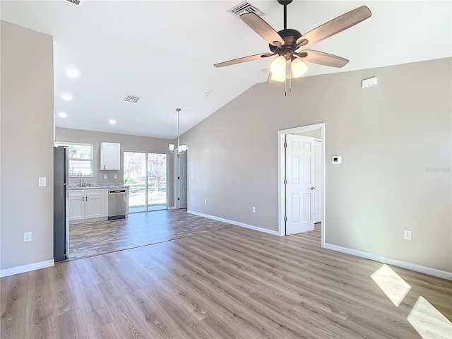 unfurnished living room featuring ceiling fan with notable chandelier, sink, lofted ceiling, and light hardwood / wood-style floors