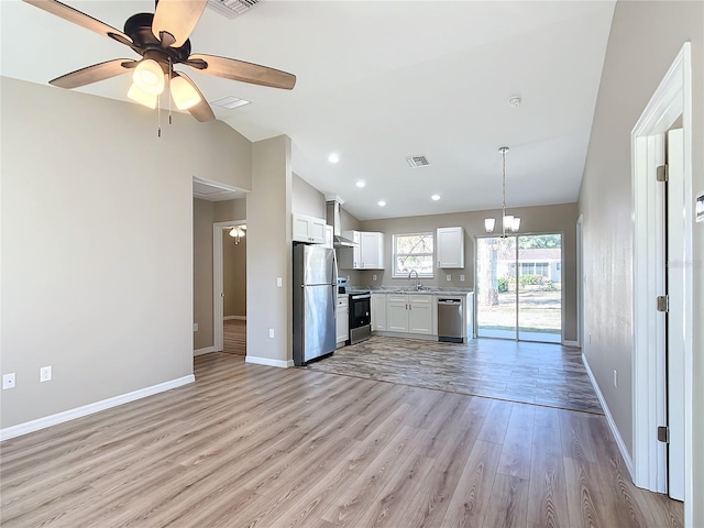 kitchen featuring white cabinets, light hardwood / wood-style floors, appliances with stainless steel finishes, and ceiling fan with notable chandelier