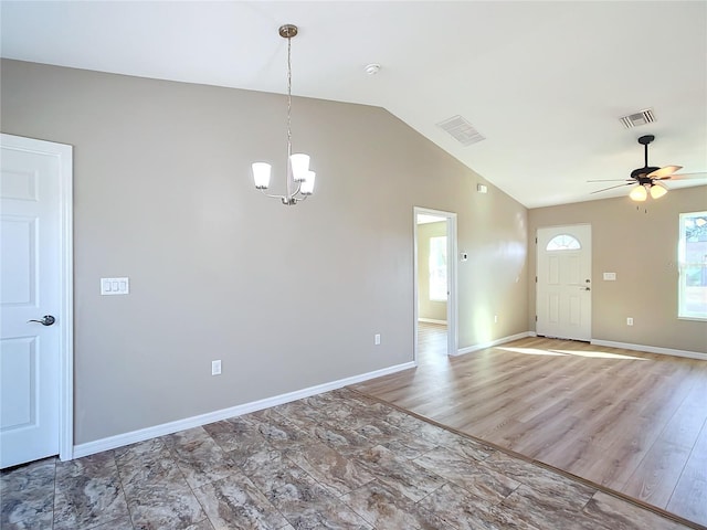 entrance foyer with ceiling fan with notable chandelier and lofted ceiling