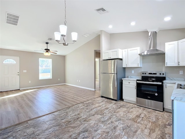 kitchen with stainless steel appliances, white cabinetry, and wall chimney exhaust hood