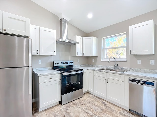 kitchen featuring sink, white cabinets, wall chimney range hood, and appliances with stainless steel finishes