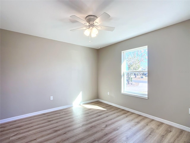 spare room featuring light hardwood / wood-style floors and ceiling fan