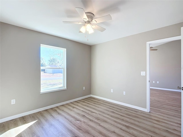 spare room with ceiling fan and light hardwood / wood-style flooring