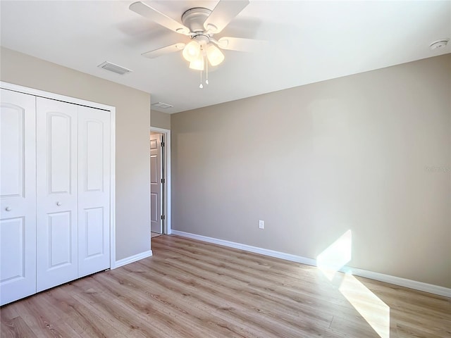 unfurnished bedroom with ceiling fan, light hardwood / wood-style floors, and a closet