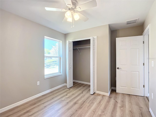 unfurnished bedroom with a closet, ceiling fan, and light hardwood / wood-style flooring