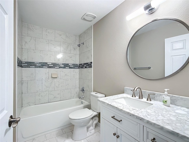 full bathroom featuring vanity, tiled shower / bath combo, and toilet