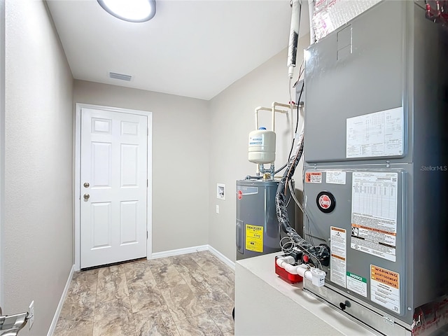 utility room with water heater and heating unit