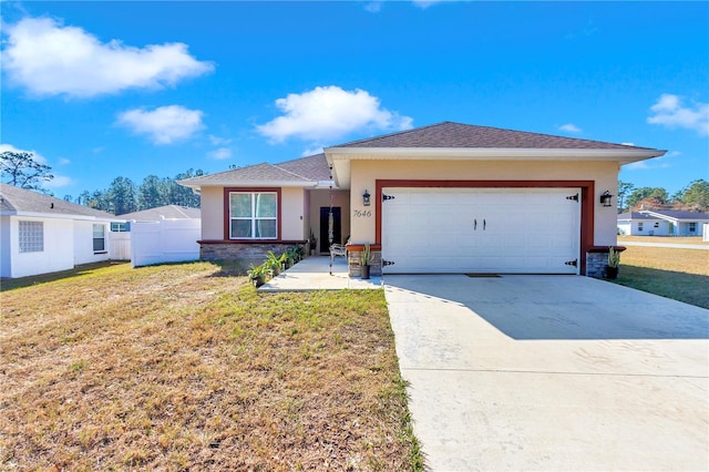 view of front of home featuring a garage and a front lawn