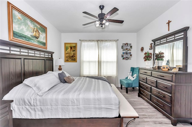 bedroom featuring multiple windows and light wood-style flooring