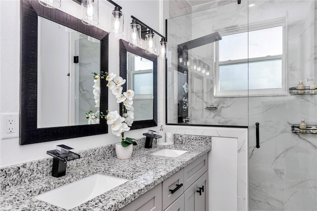 full bathroom featuring a sink, a marble finish shower, and double vanity