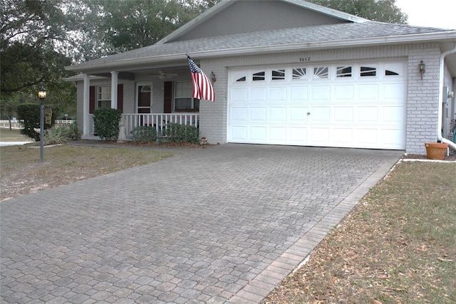 view of front of house featuring a porch and a garage