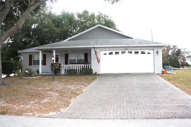 single story home featuring covered porch and a garage