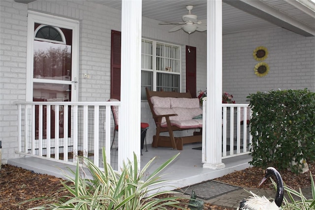 property entrance with ceiling fan and a porch