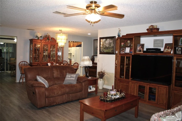 living room with a textured ceiling, ceiling fan with notable chandelier, and wood-type flooring