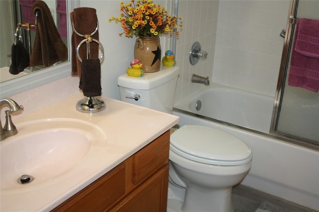 full bathroom with bath / shower combo with glass door, vanity, and toilet