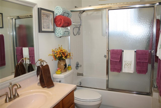 full bathroom with shower / bath combination with glass door, vanity, and toilet