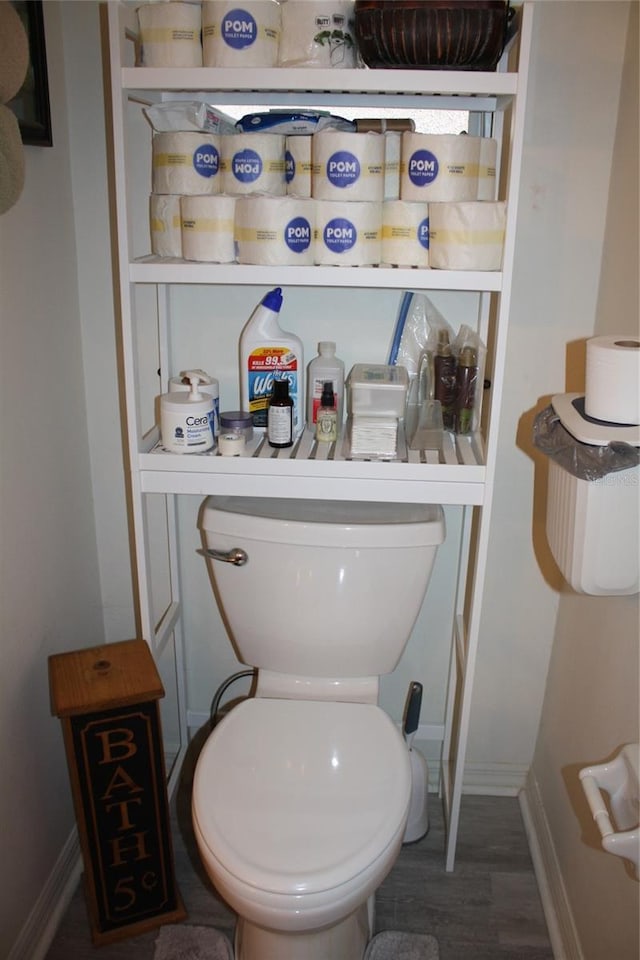 bathroom with toilet and wood-type flooring