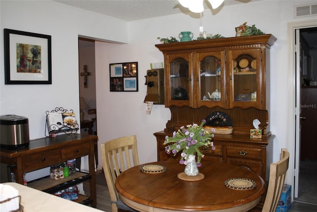 dining space with a textured ceiling