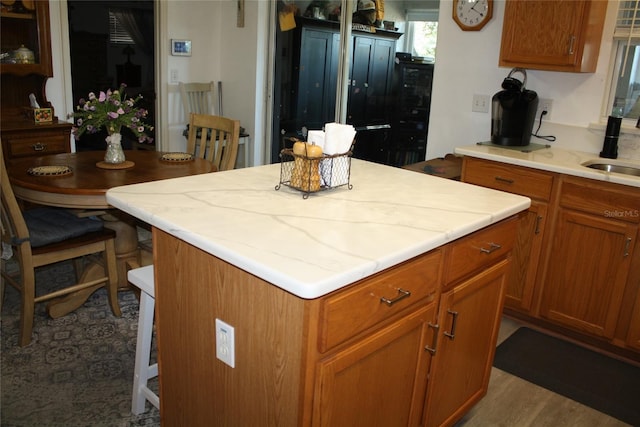 kitchen featuring sink, light hardwood / wood-style flooring, and a center island