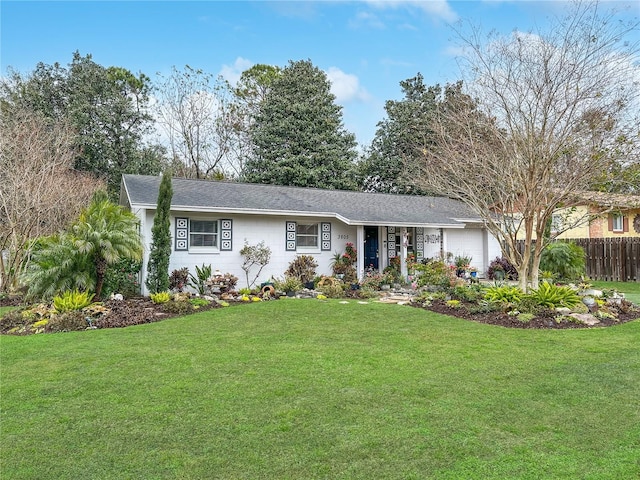 ranch-style home featuring a garage and a front lawn