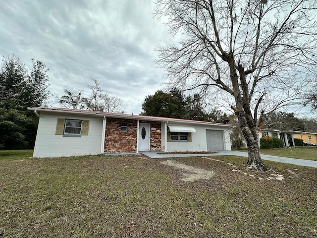 ranch-style home featuring a garage and a front lawn