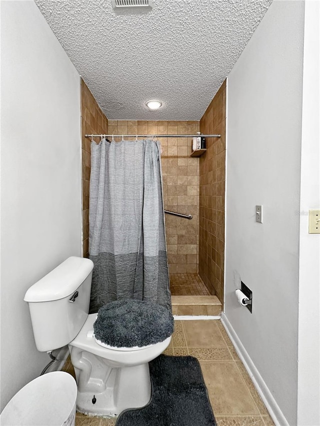 bathroom featuring walk in shower, tile patterned flooring, and toilet